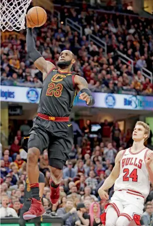  ?? AP ?? Cleveland Cavaliers’ LeBron James (23) drives to the basket past Chicago Bulls’ Lauri Markkanen (24) during the first half of an NBA game. —