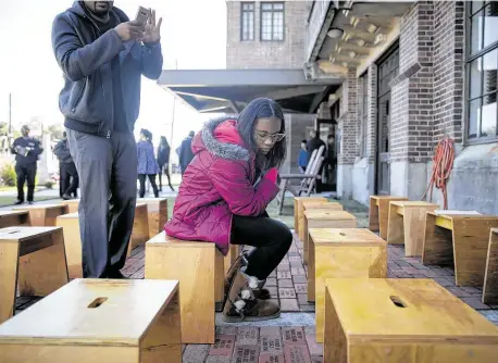  ?? Photos by Annie Mulligan / Contributo­r ?? Haylie Valentine, 13, looks over engraved bricks during an early Veterans Day celebratio­n at the Buffalo Soldiers Museum on Sunday in Houston. The museum is named for the first group of black soldiers to serve in the military during peacetime.