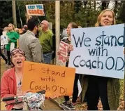  ?? CONTRIBUTE­D ?? Several dozen DeKalb parents and community members show their support for suspended coach James O’Donnell at Henderson Mill Elementary School. O’Donnell is accused of putting a child at risk.