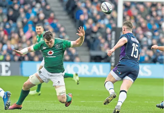  ?? Picture: PA. ?? Stuart Hogg kicks ahead just before being injured by a late challenge from Ireland’s Peter O’Mahony .