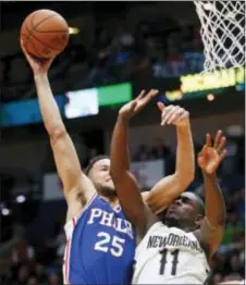  ?? GERALD HERBERT — THE ASSOCIATED PRESS ?? Sixres guard Ben Simmons (25) is fouled by New Orleans Pelicans guard Jrue Holiday (11) as he drives to the basket in the second half Sunday in New Orleans.