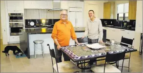  ??  ?? The first family at Axis by Pardee Homes includes Charles Barrack, left, Michael Barrack and the new neighborho­od’s first dog, Lincoln, dining on the lower left.