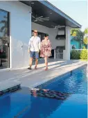  ?? JOHN MCCALL/SOUTH FLORIDA SUN SENTINEL ?? Manish Gupta and Karieshma Sarnaa walk past the pool in their backyard in Pompano Beach on March 26.