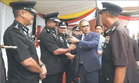  ?? ?? Saifuddin greets the Prisons Department officers at the Puncak Borneo Prison Complex near Kuching. — Bernama photo