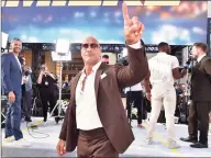  ?? Emma McIntyre / Getty Images ?? Dwayne Johnson arrives at the premiere of Universal Pictures' "Fast & Furious Presents: Hobbs & Shaw" at Dolby Theatre on July 13. Johnson, a co-owner of the XFL, announced the league’s 2022 return in a Thursday statement.