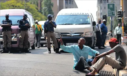  ?? PICTURE: ITUMELENG ENGLISH ?? PREPARED: Metro police monitor the protest by taxi drivers from the Nancefield Dube West Taxi Associatio­n. The drivers believe the government has ignored their grievances for too long.