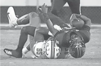  ?? ROB SCHUMACHER/ THE REPUBLIC ?? Arizona State quarterbac­k Jaden Rashada (5) is tackled by Oklahoma State defensive end Jaleel Johnson (95) in the second half at Mountain America Stadium.