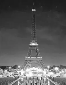  ?? — AFP photo ?? This photo taken in Paris shows the lights of the Eiffel Tower turned off at midnight to pay hommage to victims of two terror attacks in Baghdad.