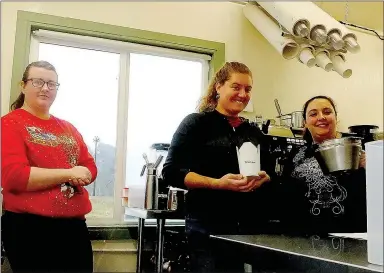  ?? Lynn Atkins/The Weekly Vista ?? Inside the small food truck parked next to Highway 71, Riley Leinen, barista; Emily Krol, assistant manager; and Beth Bishop, manager, are waiting to serve all kinds of coffee drinks and some unique cereal creations.