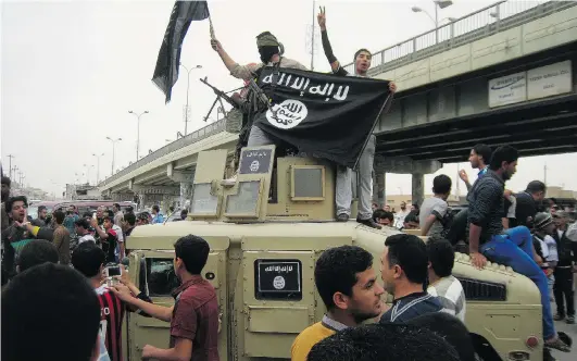  ?? THE ASSOCIATED PRESS FILE ?? Islamic State militants, shown waving al-Qaida flags as they patrol in a commandeer­ed Iraqi military vehicle in Fallujah last March, fought for 10 months before overcoming Faisal al-Gaoud’s Albu Nimr tribe in western Iraq.