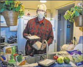  ??  ?? “Thank you,” says Wendell, who lives in Las Vegas, as he unpacks the food he received from the 24Meals challenge.