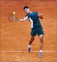  ?? Clive Brunskill / Getty Images ?? Carlos Alcaraz plays a forehand against Novak Djokovic in the semifinals of the Madrid Open on May 7.