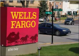  ?? DAVID ZALUBOWSKI — THE ASSOCIATED PRESS ?? Restrictio­ns are being eased on banking giant Wells Fargo, which means the financial institutio­n can begin to rebuild its reputation and grow again.