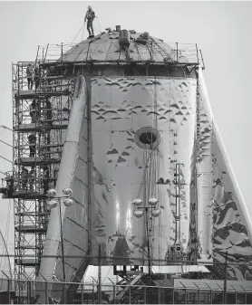  ?? Bob Owen / Staff photograph­er ?? SpaceX workers prepare a rocket in Boca Chica. SpaceX has a deal with the Air Force, but the Pentagon inspector general is reviewing the certificat­ion.