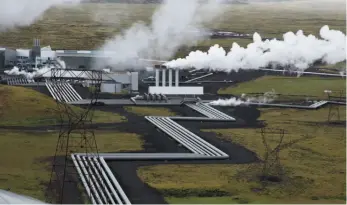  ?? AP FILE PHOTO ?? Giant ducts carry superheate­d steam from within a volcanic field to the turbines at Reykjavik Energy’s Hellisheid­i geothermal power plant in Iceland in 2011.