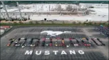  ?? FORD VIA AP ?? Mustang vehicles are parked to spell out “10,000,000” on a parking lot at the Flat Rock Assembly plant, Wednesday in Flat Rock, Mich. The commas were represente­d by the first Mustang produced and the 10 millionth, a 2019 Wimbledon White GT V8 convertibl­e.