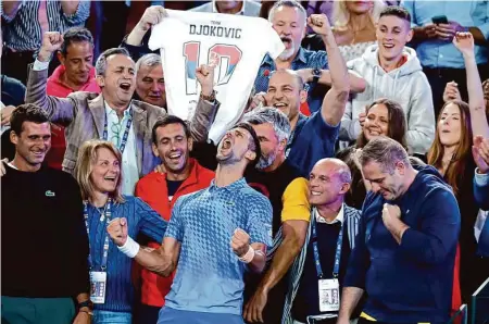  ?? Asanka Brendon Ratnayake/Associated Press ?? Novak Djokovic (center) rejoices with his team after beating Stefanos Tsitsipas in the men’s singles final at the Australian Open.