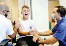  ?? — Reuters ?? A youth receives a vaccinatio­n against Covid-19 after Israel approved the usage of the vaccine for youngsters aged 12-15, at a Clalit healthcare maintenanc­e organisati­on in Ashkelon.