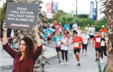  ?? AFP ?? A protester holds a sign with a message against sexual assault during the 16th edition of the Beirut Marathon in the Lebanese capital on Sunday.