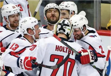  ?? Associated Press ?? ■ In this May 7 file photo, Washington Capitals goaltender Braden Holtby (70) celebrates with Evgeny Kuznetsov (92), Jakub Vrana (13), Alex Ovechkin, top center, and Matt Niskanen (2) after Kuznetsovs' game-winning goal in the overtime period in Game 6...