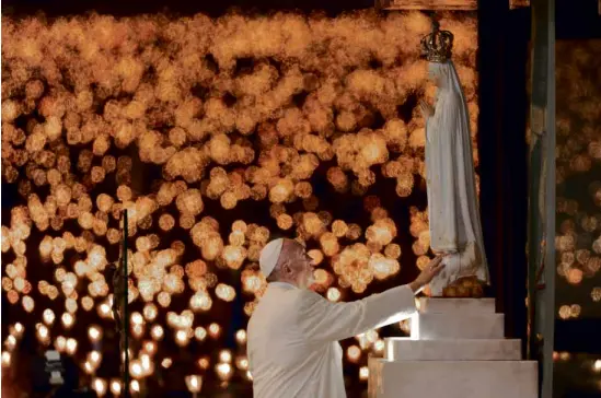  ?? —AP ?? Pope Francis leads a candleligh­t vigil at the Sanctuary of Our Lady of Fatima on Friday in Fatima, Portugal.