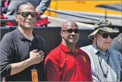  ?? Brian Rothmuller Icon Sportswire ?? AL COWLINGS, left, and USC Athletic Director Lynn Swann, center, are longtime friends of school benefactor B. Wayne Hughes, right.