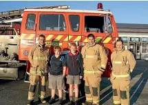  ??  ?? Tuatapere Volunteer Fire Brigade members with a couple of young ride-winning raffle winners. Volunteers are needed for emergency help as well as a host of less dramatic events and services that enhance community life.