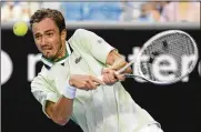  ?? ANDY BROWNBILL / ASSOCIATED PRESS ?? Daniil Medvedev plays a backhand return to Botic van de Zandschulp of the Netherland­s during his third-round win at the Australian Open on Saturday.