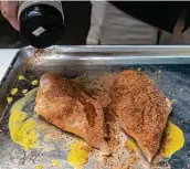  ??  ?? A dry rub is sprinkled on a chicken breast after a commercial butter sauce was put on it as a binder.