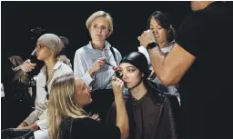  ??  ?? A behind-the-scenes look at make-up artists working on models backstage during Tom Ford’s show at New York Fashion Week