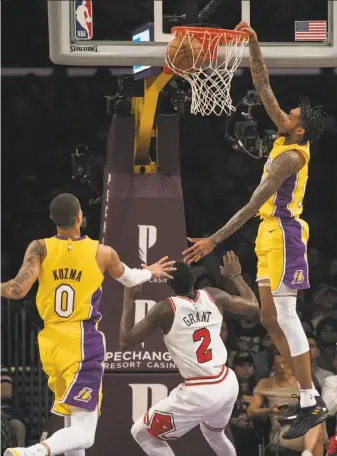 ?? Kyusung Gong / Associated Press ?? Lakers forward Brandon Ingram soars for a dunk over Chicago guard Jerian Grant.