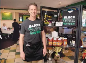  ?? MARLA BROSE/.JOURNAL ?? Rick Camuglia of Paisano’s Italian Restaurant wears one of the “Black Olives Matter” T-shirts that he sells.