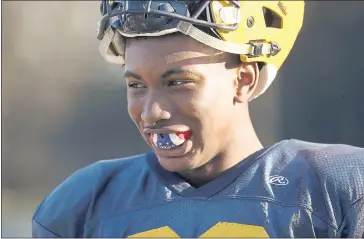  ?? PHOTOS BY NHAT V. MEYER — STAFF PHOTOGRAPH­ER ?? Menlo School football player Jaden Richardson displays his mouth guard with built-in sensors. These devices are being used in a Stanford research project to study concussion­s in youth.