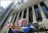  ?? KATHY WILLENS — THE ASSOCIATED PRESS FILE ?? Vincent Pepe enjoys some fresh air outside the New York Stock Exchange where he works in the Financial District in New York. U.S. stocks notched solid gains Wednesday, recouping some of the market’s losses from a day earlier.