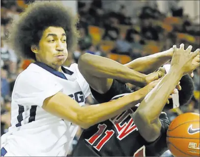  ?? JEFF SWINGER/ USA TODAY ?? Utah State wing Jalen Moore, left, fouls UNLV forward Goodluck Okonoboh on Feb. 24, 2015, at Logan, Utah. Moore, a senior, led the Aggies in scoring (15.2 points per game) and rebounding (6.0) last season.