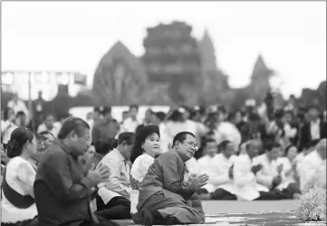  ??  ?? Hun Sen (front) holds a ceremony at the Angkor Wat temple to pray for peace and stability in Cambodia. — Reuters photo