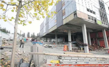  ?? ADRIAN LAM, TIMES COLONIST ?? A constructi­on crew works at Camosun’s new Alex and Jo Campbell Centre for Health and Wellness at the college’s Interurban campus in Saanich. Completion of the $48.5-million building is expected next year.