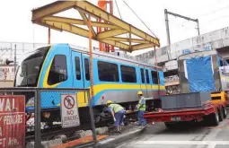  ??  ?? NEW MRT COACH—Engineers and workers assemble the new coaches at the Metro Rail Transit (MRT) EDSA-Taft station in Pasay City. In 2013, the government purchased 48 coaches from a Chinese firm as part of then-Department of Transporta­tion and...