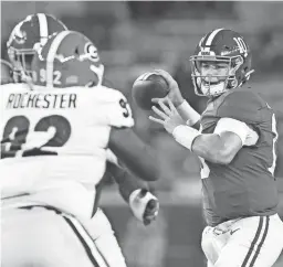  ?? GARY COSBY JR./TUSCALOOSA NEWS ?? Alabama quarterbac­k Mac Jones throws a pass against Georgia on Saturday night in Tuscaloosa, Ala.