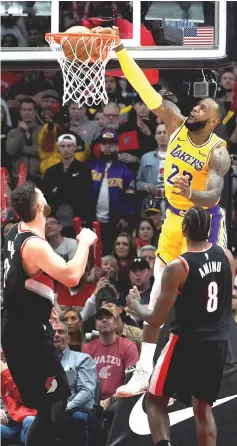  ??  ?? Los Angeles Lakers forward LeBron James dunks the ball on Portland Trail Blazers center Jusuf Nurkic during the second half of the game at the Moda Centre. — USA TODAY Sports photo