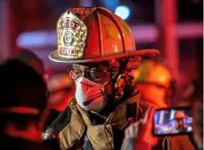  ?? Pittsburgh Post-Gazette ?? Darryl Jones speaks with members of the media as firefighte­rs respond to a three-alarm fire in the Strip District in April 2020.