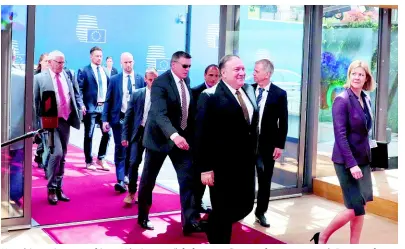  ??  ?? United States Secretary of State Mike Pompeo (left, foreground) arrives for a meeting with European foreign ministers at the Europa building in Brussels yesterday.