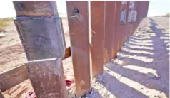 ?? AP PHOTO/GREGORY BULL ?? One of the steel columns of the border wall separating Arizona and Mexico is cut below a recent repair Friday near Lukeville, Ariz.