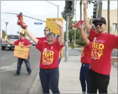  ?? WILLIAM ROLLER PHOTO ?? Employees of Wells Fargo Bank on Main Street solicit for Red Shoe Day in El Centro.