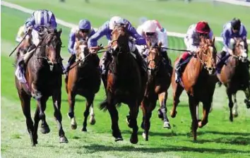  ?? Rex Features ?? House on fire Winter House, ridden James Doyle (white cap), winning the Swan At Lavenham Wood Ditton Stakes from Mustaaqeem (left) at Newmarket Racecourse yesterday.