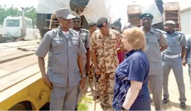  ??  ?? From left: Comptrolle­r of Customs in charge of Adamawa and Taraba states, Kamardeen Olumoh, hands over the intercepte­d six ‘Mine-Resistant and Multi-Purpose’ military vehicles to Kathleen FitzGibbon, Deputy Chief Mission, US Embassy in Nigeria in Yola yesterday. With them is the Brigadier Commander, 23 Armoured Brigade, Yola, Brig.-Gen. Muhammed Gambo Photo: NAN