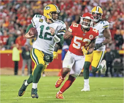  ?? JAY BIGGERSTAF­F/USA TODAY SPORTS ?? Aaron Rodgers, rushing for yardage against the Chiefs, has completed 65.4% of his passes for 2,324 yards and 16 TDs as the Packers went 7-1 and he emerged as an MVP candidate in the season’s first half.