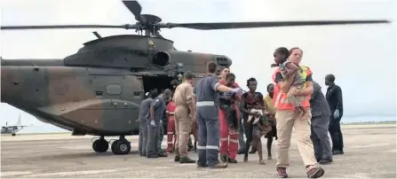  ??  ?? RESCUE workers from Kwazulu-natal help people disembark from a helicopter in Beira, Mozambique this week. The SANDF sent a teams to Mozambique and Malawi which are struggling in the aftermath of the damage and flooding caused by Cyclone Idai. Many humanitari­an organisati­ons have responded to the crisis as well. | IPSS Medical Rescue REUTERS