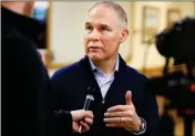  ?? JOSH GALEMOR/THE CASPER STAR-TRIBUNE VIA AP ?? EPA ADMINISTRA­TOR SCOTT PRUITT talks with local media following a press conference after taking a tour of the Black Thunder coal mine outside of Wright, Wyo., on Thursday.