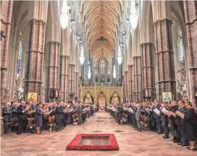  ?? RICHARD POHLE/AP ?? Members of the congregati­on sing during a Service of Thanksgivi­ng for the life of Prince Philip, Duke of Edinburgh, at Westminste­r Abbey in London on Tuesday.